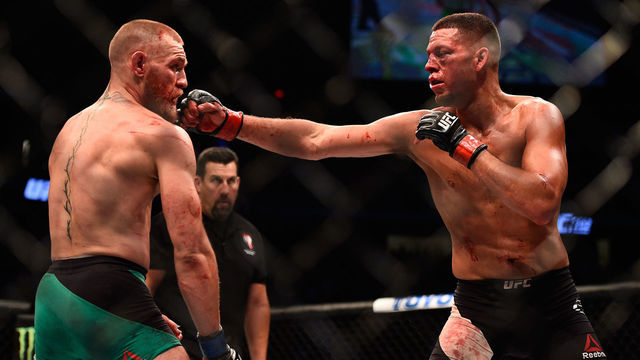 LAS VEGAS, NV - AUGUST 20: (R-L) Nate Diaz punches Conor McGregor of Ireland in their welterweight bout during the UFC 202 event at T-Mobile Arena on August 20, 2016 in Las Vegas, Nevada.