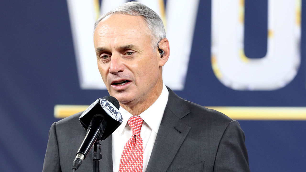ARLINGTON, TX - OCTOBER 27: Major League Baseball Commissioner Robert D. Manfred Jr. presents the Commissioners Trophy to Los Angeles Dodgers Owner Mark Walter after the Dodgers defeated the Tampa Bay Rays in Game 6 to clinch the 2020 World Series at Globe Life Field on Tuesday, October 27, 2020 in Arlington, Texas.