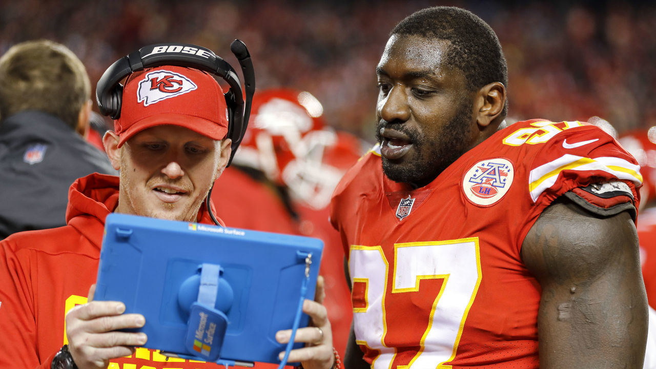 KANSAS CITY, MO - DECEMBER 30: Allen Bailey #97 of the Kansas City Chiefs looks at a tablet with Chiefs defensive line coach Britt Reid during the game against the Oakland Raiders at Arrowhead Stadium on December 30, 2018 in Kansas City, Missouri.