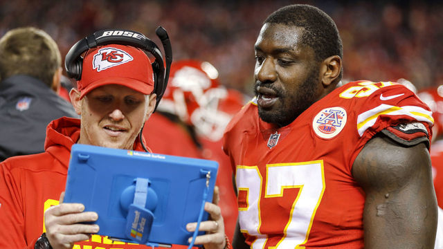 KANSAS CITY, MO - DECEMBER 30: Allen Bailey #97 of the Kansas City Chiefs looks at a tablet with Chiefs defensive line coach Britt Reid during the game against the Oakland Raiders at Arrowhead Stadium on December 30, 2018 in Kansas City, Missouri.