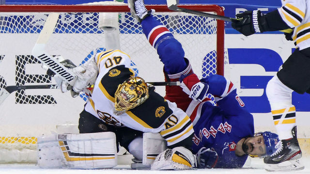 NEW YORK, NEW YORK - FEBRUARY 10: Chris Kreider #20 of the New York Rangers falls over Tuukka Rask #40 of the Boston Bruins during the third period at Madison Square Garden on February 10, 2021 in New York City.