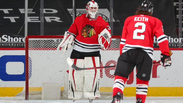 CHICAGO, IL - JANUARY 31: Kevin Lankinen #32 celebrates with Duncan Keith #2 of the Chicago Blackhawks after the Chicago Blackhawks defeated the Columbus Blue Jackets 3-1 at United Center on January 31, 2021 in Chicago, Illinois.