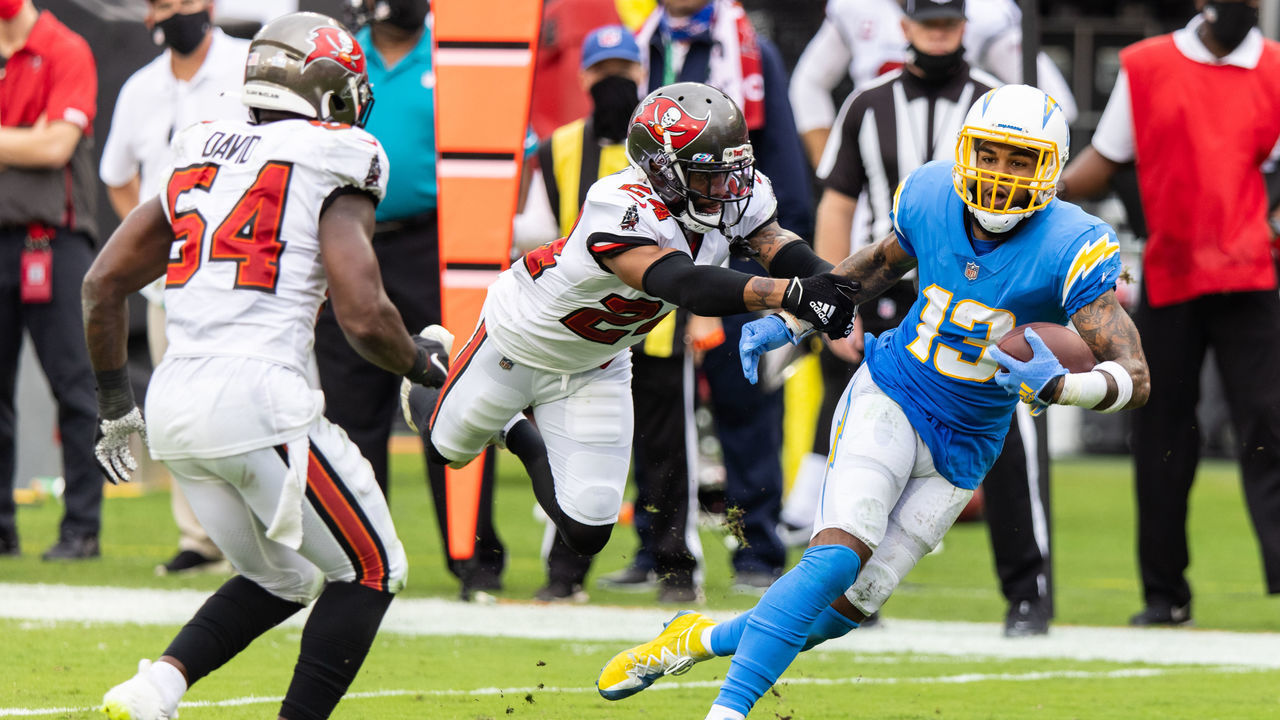 TAMPA, FLORIDA - OCTOBER 04: Keenan Allen #13 of the Los Angeles Chargers runs for yardage after catching a pass against Carlton Davis #24 of the Tampa Bay Buccaneers during the third quarter of a game at Raymond James Stadium on October 04, 2020 in Tampa, Florida.