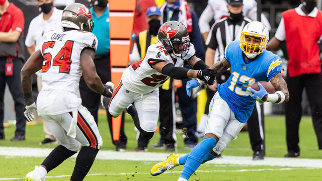 TAMPA, FLORIDA - OCTOBER 04: Keenan Allen #13 of the Los Angeles Chargers runs for yardage after catching a pass against Carlton Davis #24 of the Tampa Bay Buccaneers during the third quarter of a game at Raymond James Stadium on October 04, 2020 in Tampa, Florida.