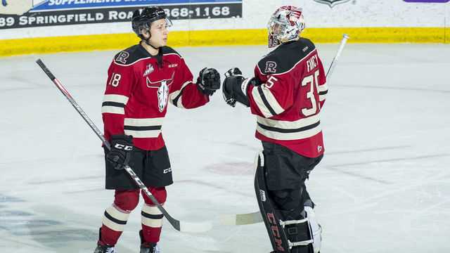 KELOWNA, BC - FEBRUARY 15: Jace Isley #18 fist bumps Byron Fancy #35 of the Red Deer Rebels to celebrate a goal against the Kelowna Rockets at Prospera Place on February 15, 2020 in Kelowna, Canada.