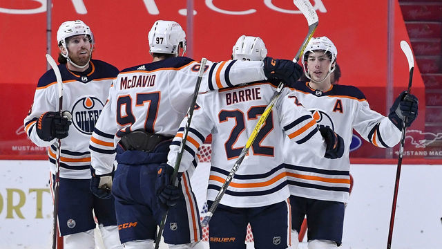 MONTREAL, QC - FEBRUARY 11: Tyson Barrie #22 of the Edmonton Oilers celebrates with teammates after scoring a goal against the Montreal Canadiens in the NHL game at the Bell Centre on February 11, 2021 in Montreal, Quebec, Canada.