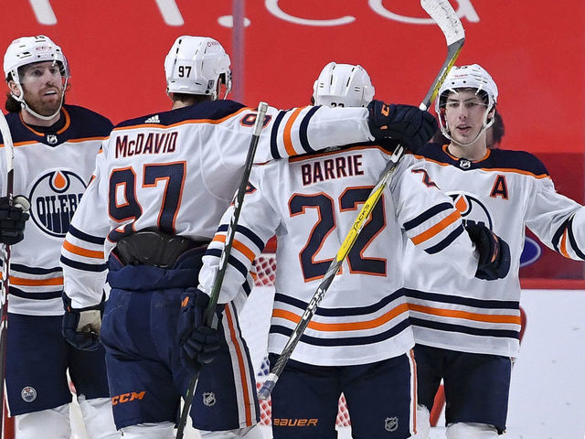 MONTREAL, QC - FEBRUARY 11: Tyson Barrie #22 of the Edmonton Oilers celebrates with teammates after scoring a goal against the Montreal Canadiens in the NHL game at the Bell Centre on February 11, 2021 in Montreal, Quebec, Canada.