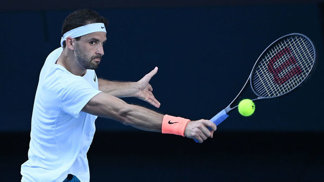 MELBOURNE, AUSTRALIA - FEBRUARY 14: Grigor Dimitrov of Bulgaria plays a backhand in his Men's Singles fourth round match against Dominic Thiem of Austria during day seven of the 2021 Australian Open at Melbourne Park on February 14, 2021 in Melbourne, Australia.