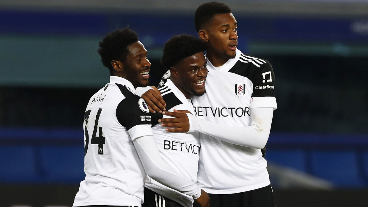 LIVERPOOL, ENGLAND - FEBRUARY 14: Josh Maja of Fulham celebrates with team mates Ola Aina and Tosin Adarabioyo after scoring their side's second goal during the Premier League match between Everton and Fulham at Goodison Park on February 14, 2021 in Liverpool, England. Sporting stadiums around the UK remain under strict restrictions due to the Coronavirus Pandemic as Government social distancing laws prohibit fans inside venues resulting in games being played behind closed doors.
