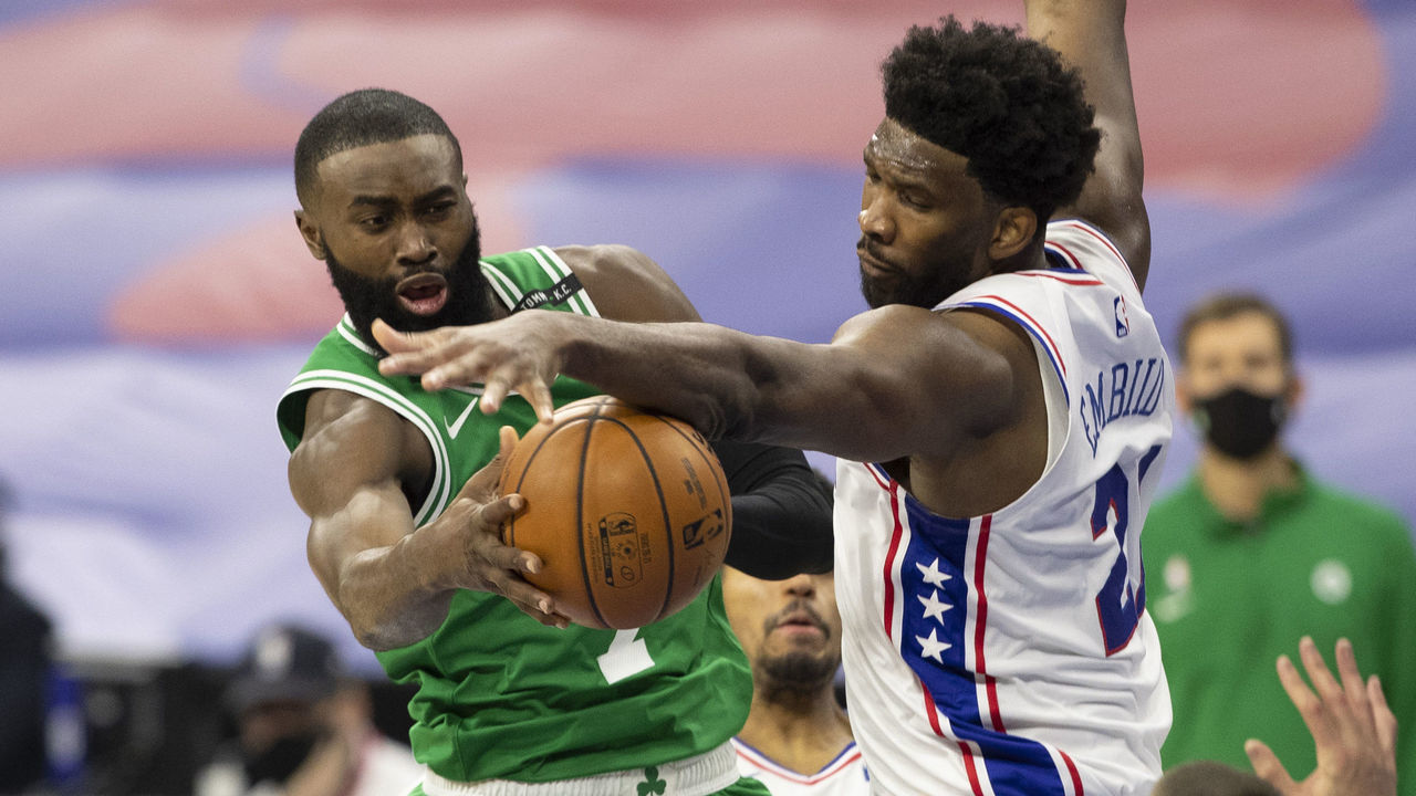 PHILADELPHIA, PA - JANUARY 20: Jaylen Brown #7 of the Boston Celtics passes the ball against Joel Embiid #21 of the Philadelphia 76ers at the Wells Fargo Center on January 20, 2021 in Philadelphia, Pennsylvania. The 76ers defeated the Celtics 117-109.