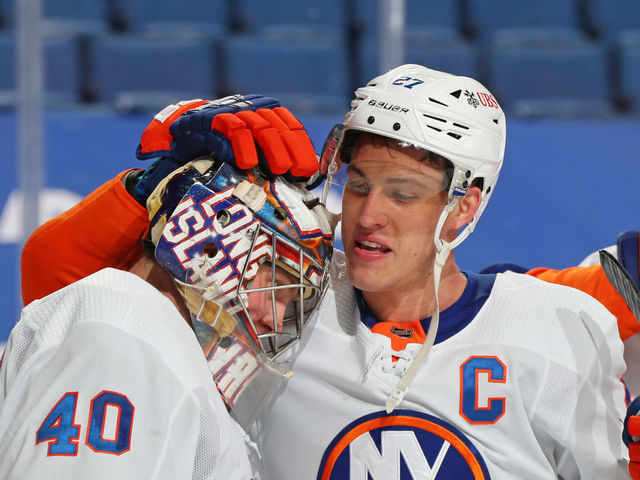 BUFFALO, NY - FEBRUARY 15: Semyon Varlamov #40 and Anders Lee #27 of the New York Islanders celebrate their 3-1 victory against the Buffalo Sabres following an NHL game on February 15, 2021 at KeyBank Center in Buffalo, New York.