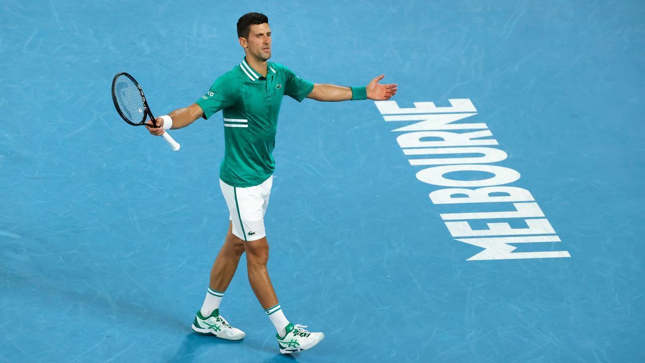 Serbia's Novak Djokovic reacts as he plays against Germany's Alexander Zverev during their men's singles quarter-final match on day nine of the Australian Open tennis tournament in Melbourne on February 16, 2021.