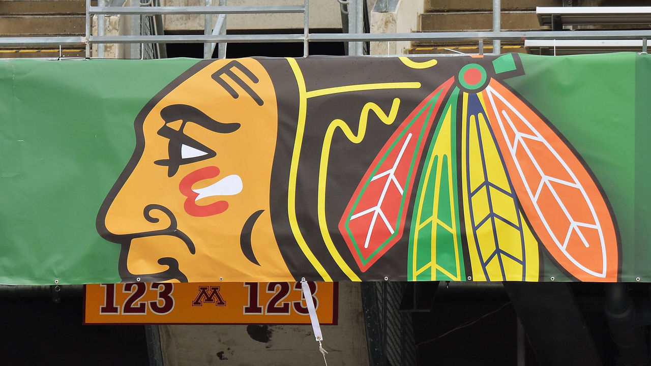 MINNEAPOLIS, MN - FEBRUARY 19: A worker installs a banner with the logo from the Chicago Blackhawks as part of the preparations for the 2016 Coors Light Stadium Series game between the Minnesota Wild and Chicago Blackhawks on February 19, 2016 at TCF Bank Stadium in Minneapolis, Minnesota.