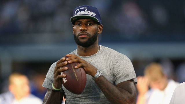 ARLINGTON, TX - SEPTEMBER 08: NBA player Lebron James of the Miami Heat throws a football at AT&T Stadium before a Sunday night game between the New York Giants and the Dallas Cowboys on September 8, 2013 in Arlington, Texas.