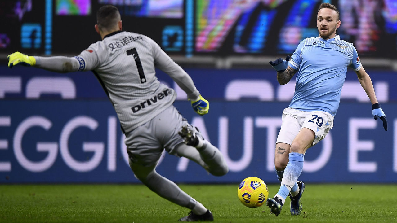 STADIO GIUSEPPE MEAZZA, MILAN, ITALY - 2021/02/14: Manuel Lazzari (R) of SS Lazio competes for the ball with Samir Handanovic of FC Internazionale during the Serie A football match between FC Internazionale and SS Lazio. FC Internazionale won 3-1 over SS Lazio.