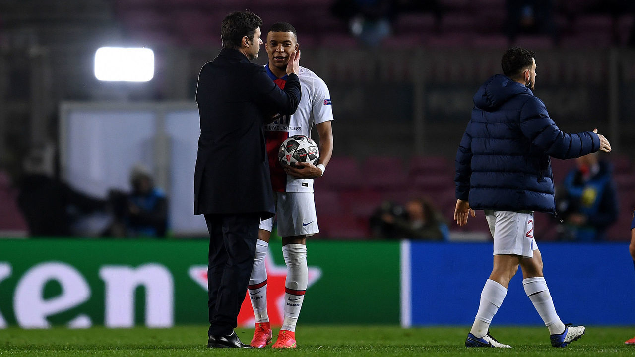 BARCELONA, SPAIN - FEBRUARY 16: Kylian Mbappe of Paris Saint-Germain is congratulated by Mauricio Pochettino, Head Coach of Paris Saint-Germain as he holds the match ball after scoring a hat-trick during the UEFA Champions League Round of 16 match between FC Barcelona and Paris Saint-Germain at Camp Nou on February 16, 2021 in Barcelona, Spain. Sporting stadiums around Spain remain under strict restrictions due to the Coronavirus Pandemic as Government social distancing laws prohibit fans inside venues resulting in games being played behind closed doors.