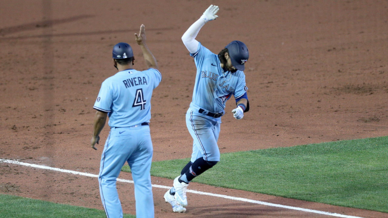 BUFFALO, NEW YORK - AUGUST 11: Bo Bichette #11 of the Toronto Blue Jays celebrates with third base coach Luis Rivera #4 after hitting a three run home run during the sixth inning of an MLB game against the Miami Marlins at Sahlen Field on August 11, 2020 in Buffalo, New York. The Blue Jays are the home team due to their stadium situation and the Canadian government’s policy on the coronavirus (COVID-19).