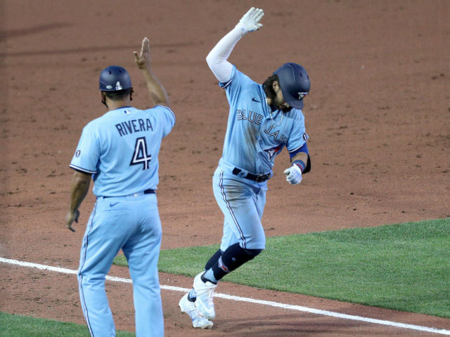BUFFALO, NEW YORK - AUGUST 11: Bo Bichette #11 of the Toronto Blue Jays celebrates with third base coach Luis Rivera #4 after hitting a three run home run during the sixth inning of an MLB game against the Miami Marlins at Sahlen Field on August 11, 2020 in Buffalo, New York. The Blue Jays are the home team due to their stadium situation and the Canadian government’s policy on the coronavirus (COVID-19).
