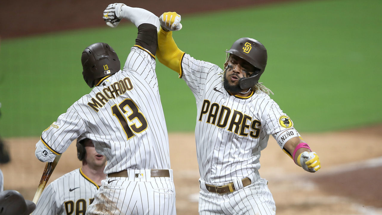 SAN DIEGO, CALIFORNIA - OCTOBER 01: Manny Machado #13 congratulates Fernando Tatis Jr. #23 of the San Diego Padres after his three-run homerun during the sixth inning of Game Two of the National League Wild Card Series against the St. Louis Cardinals at PETCO Park on October 01, 2020 in San Diego, California.