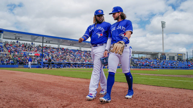 DUNEDIN, FLORIDA - FEBRUARY 27: Vladimir Guerrero Jr. #27 and Bo Bichette #11 of the Toronto Blue Jays head to the dugout during the spring training game against the Minnesota Twins at TD Ballpark on February 27, 2020 in Dunedin, Florida.