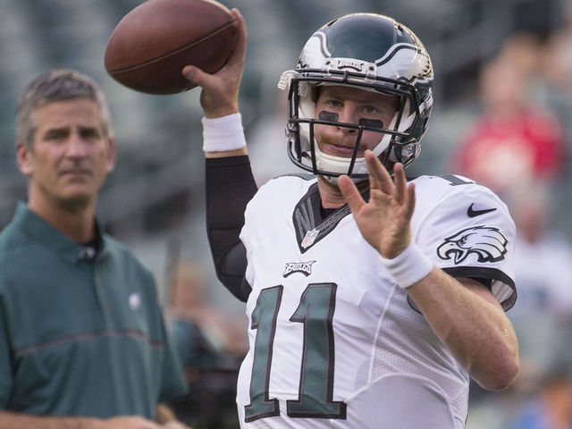 PHILADELPHIA, PA - AUGUST 11: Carson Wentz #11 of the Philadelphia Eagles warms up as offensive coordinator Frank Reich looks on prior to the game against the Tampa Bay Buccaneers at Lincoln Financial Field on August 11, 2016 in Philadelphia, Pennsylvania. The Eagles defeated the Buccaneers 17-9.