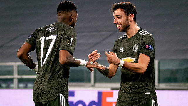 TURIN, ITALY - FEBRUARY 18: Bruno Fernandes of Manchester United celebrates scoring a goal to make the score 0-1 with Fred during the UEFA Europa League Round of 32 match between Real Sociedad and Manchester United at Allianz Stadium on February 18, 2021 in Turin, Italy.