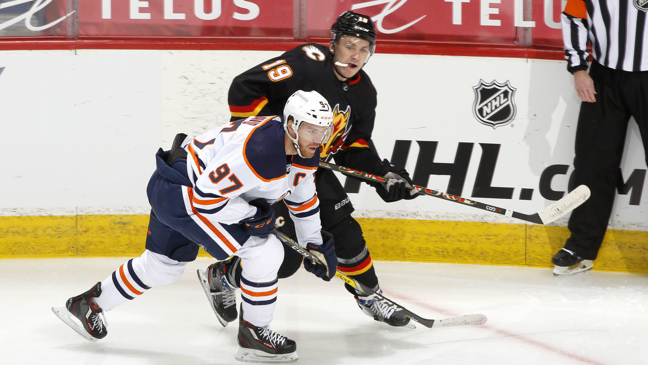 CALGARY, ALBERTA - FEBRUARY 06: Matthew Tkachuk #19 of the Calgary Flames skates against Connor McDavid #97 the Edmonton Oilers at Scotiabank Saddledome on February 06, 2021 in Calgary, Alberta.