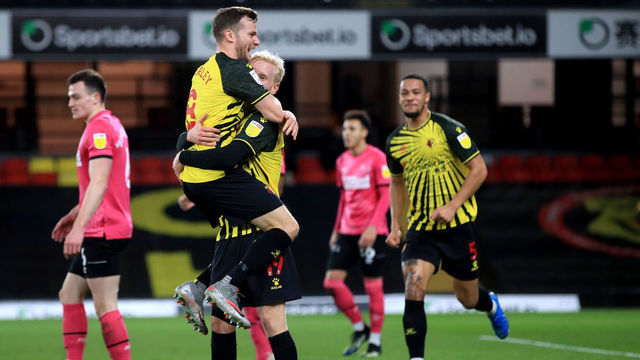 Watford's Will Hughes (third left) celebrates with team-mate Tom Cleverley after scoring their side's second goal of the game during the Sky Bet Championship match at Vicarage Road, Watford. Picture date: Friday February 19, 2021.