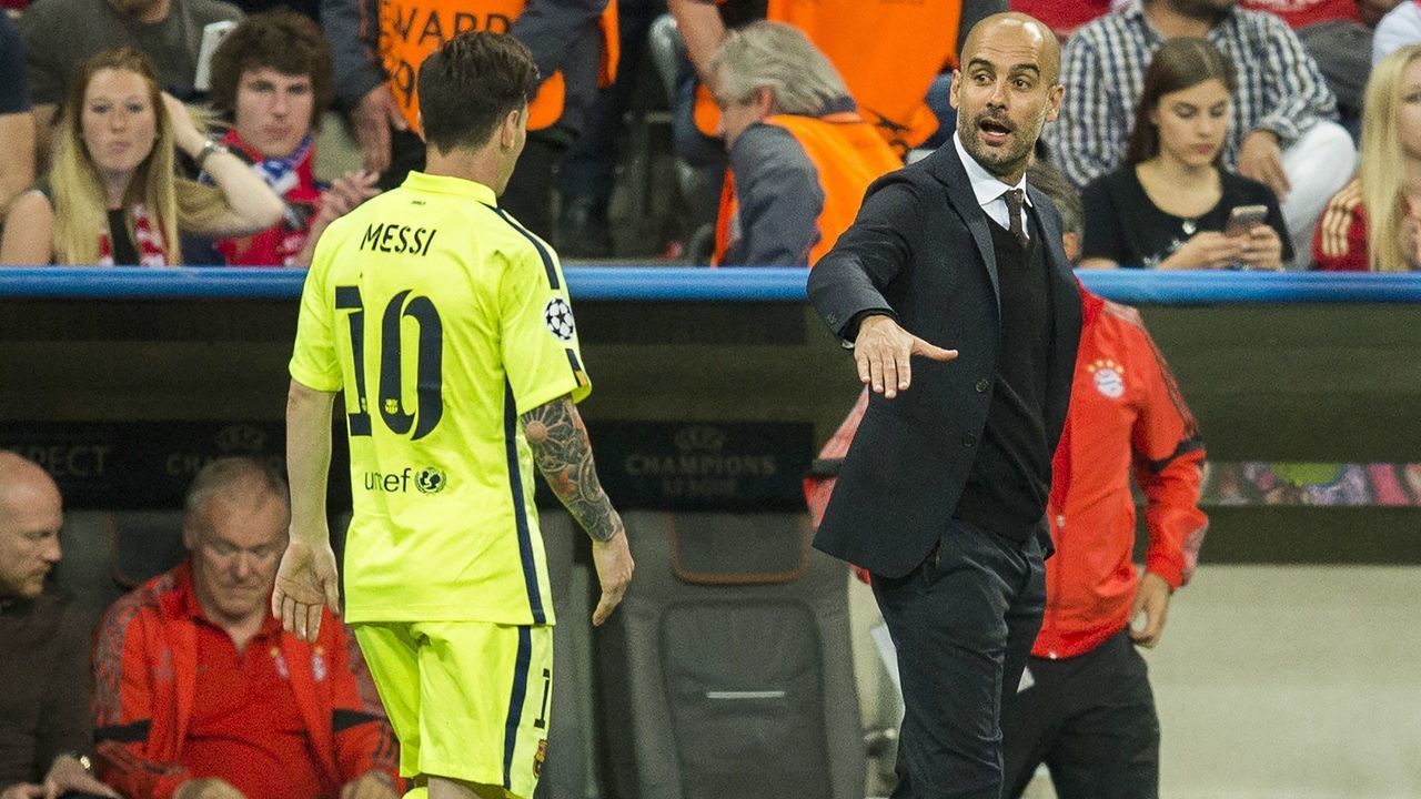 Barcelona's Argentinian forward Lionel Messi (L) is to shake hands with Bayern Munich's Spanish head coach Pep Guardiola as he leaves the pitch at half time during the UEFA Champions League football match semi final FC Bayern Munich vs FC Barcelona in Munich on May 12, 2015. AFP PHOTO / ODD ANDERSEN