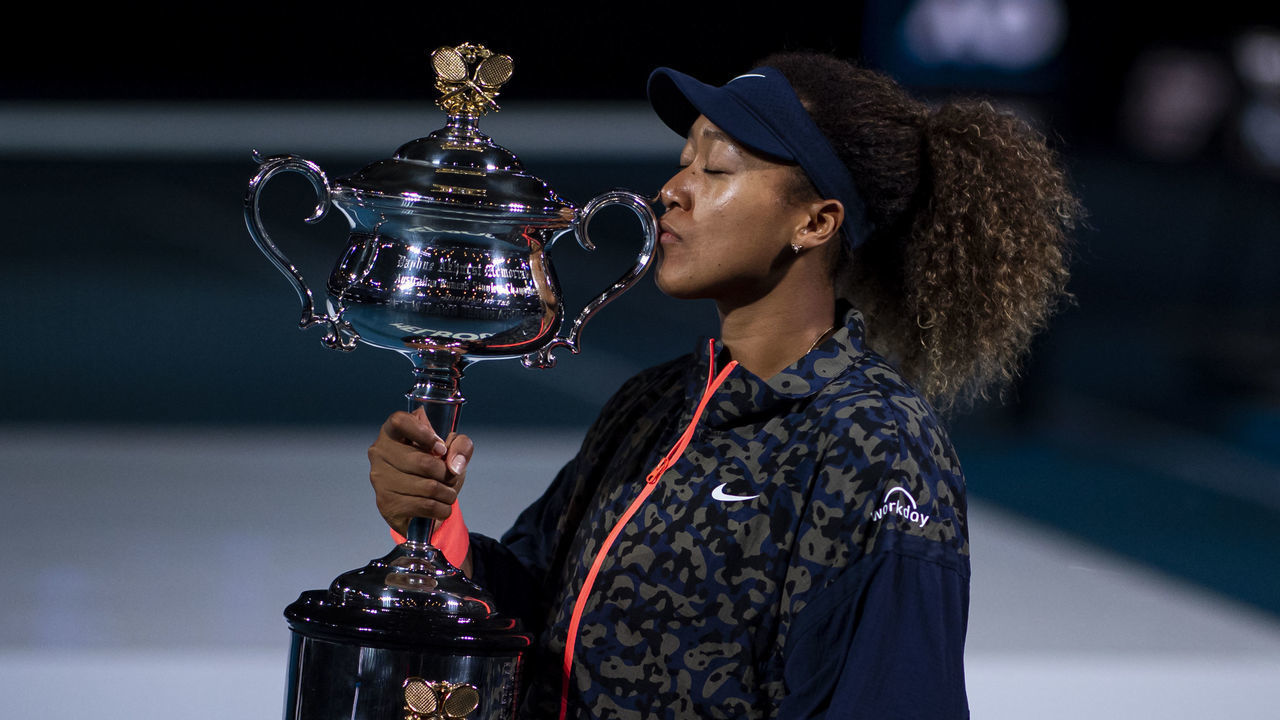 MELBOURNE, AUSTRALIA - FEBRUARY 20: Naomi Osaka of Japan celebrates with the Trophy after defeating Jennifer Brady of the United States in the women's singles final, during day 13 of the 2021 Australian Open at Melbourne Park on February 20, 2021 in Melbourne, Australia.