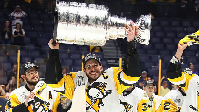 NASHVILLE, TN - JUNE 11: Sidney Crosby #87 of the Pittsburgh Penguins and his teammates celebrate with the Stanley Cup trophy after defeating the Nashville Predators 2-0 in Game Six of the 2017 NHL Stanley Cup Final at the Bridgestone Arena on June 11, 2017 in Nashville, Tennessee.