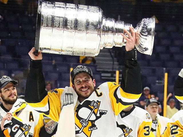 NASHVILLE, TN - JUNE 11: Sidney Crosby #87 of the Pittsburgh Penguins and his teammates celebrate with the Stanley Cup trophy after defeating the Nashville Predators 2-0 in Game Six of the 2017 NHL Stanley Cup Final at the Bridgestone Arena on June 11, 2017 in Nashville, Tennessee.