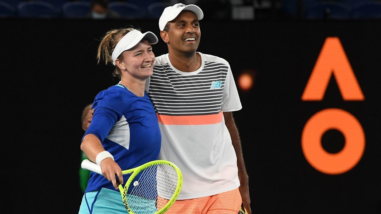 Czech Republic's Barbora Krejcikova (L) celebrates with partner Rajeev Ram of the US after winning their mixed doubles final match against Australia's Samantha Stosur and Matthew Ebden on day thirteen of the Australian Open tennis tournament in Melbourne on February 20, 2021.