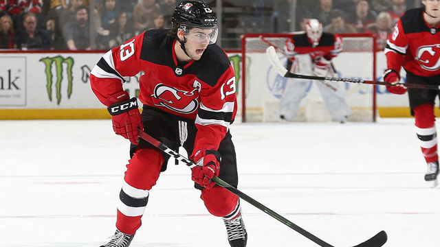 NEWARK, NJ - MARCH 10: Nico Hischier #13 of the New Jersey Devils plays the puck against the Pittsburgh Penguins during the game at the Prudential Center on March 10, 2020 in Newark, New Jersey. "n"n"n