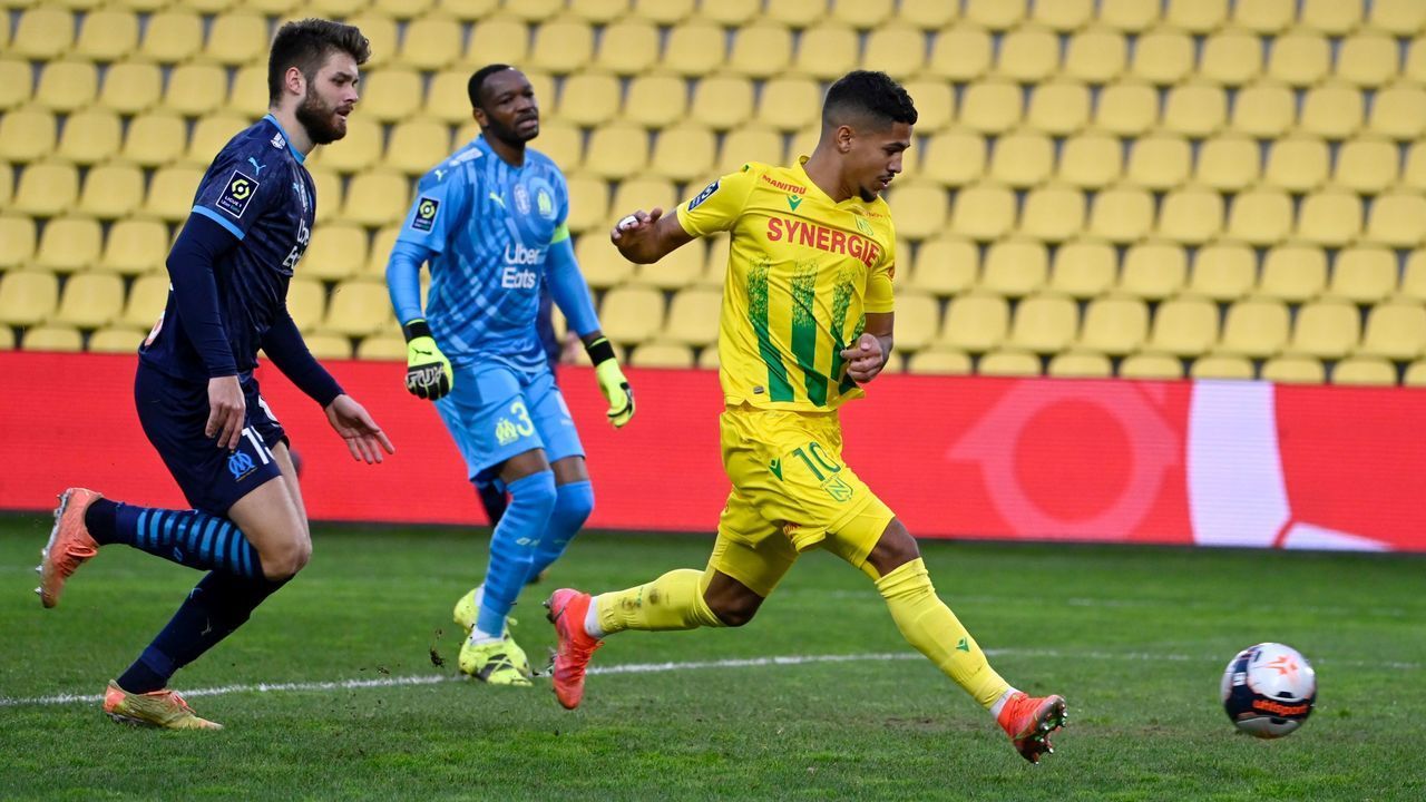 Nantes' French midfielder Ludovic Blas (R) scores a goal during the French L1 football match between Nantes FC and Olympique de Marseilles (OM) at La Beaujoire Stadium in Nantes, western France, on February 20, 2021.