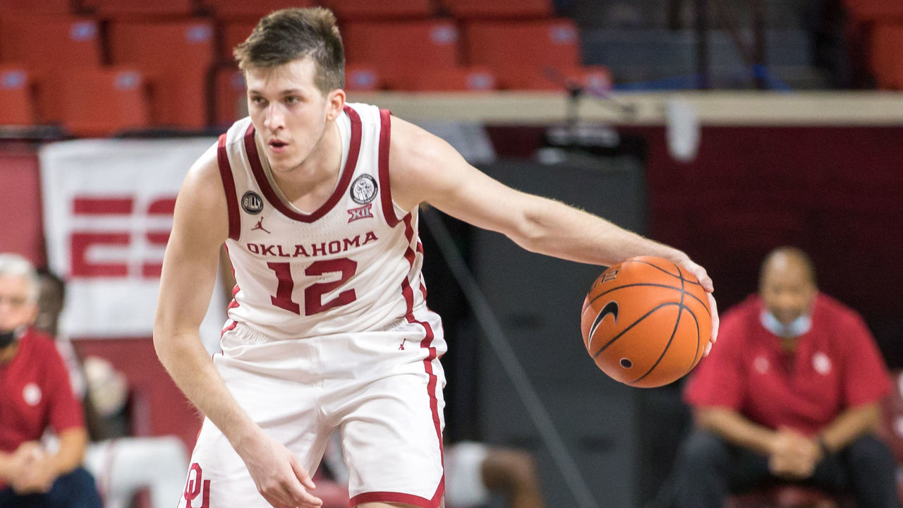 NORMAN, OK - JANUARY 23: Oklahoma Sooners guard Austin Reaves (12) brings the ball up court during the first half against the Kansas Jayhawks at the Lloyd Noble Center in Norman Oklahoma