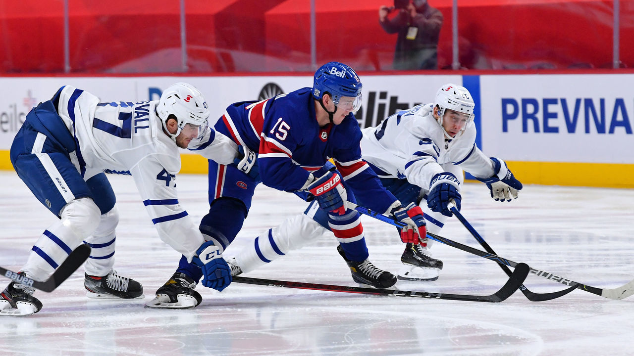 MONTREAL, QC - FEBRUARY 20: Jesperi Kotkaniemi #15 of the Montreal Canadiens skates for the puck against Pierre Engvall #47 and Ilya Mikheyev #65 of the Toronto Maple Leafs in the NHL game at the Bell Centre on February 20, 2021 in Montreal, Quebec, Canada.