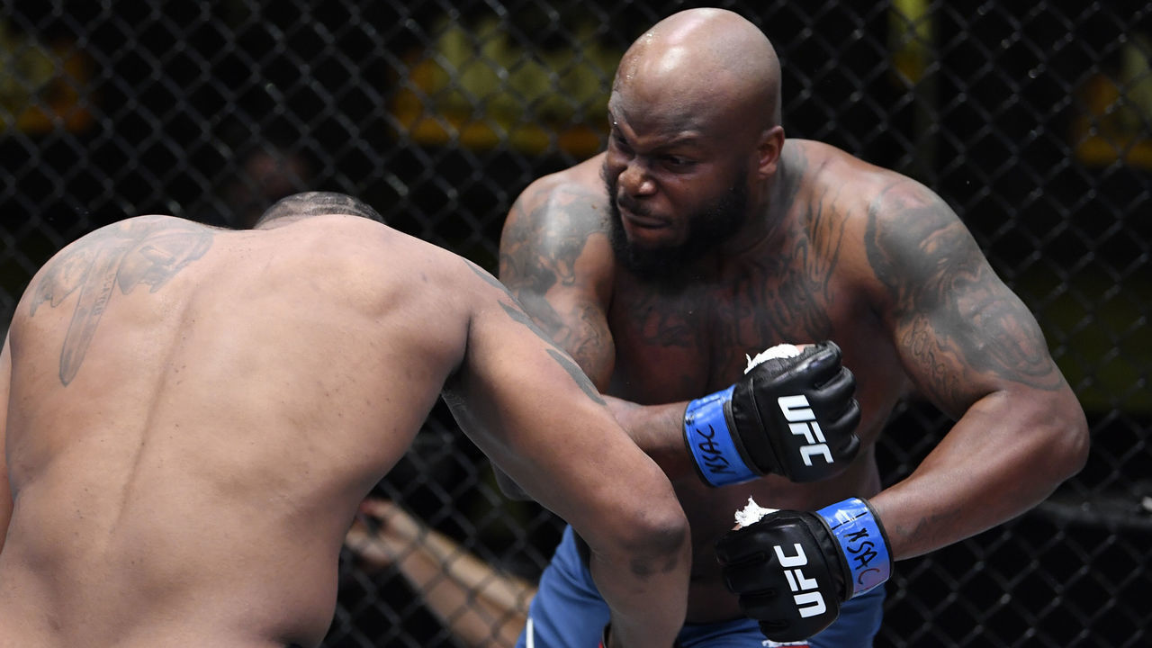 LAS VEGAS, NEVADA - FEBRUARY 20: (R-L) Derrick Lewis punches Curtis Blaydes in a heavyweight bout during the UFC Fight Night event at UFC APEX on February 20, 2021 in Las Vegas, Nevada.