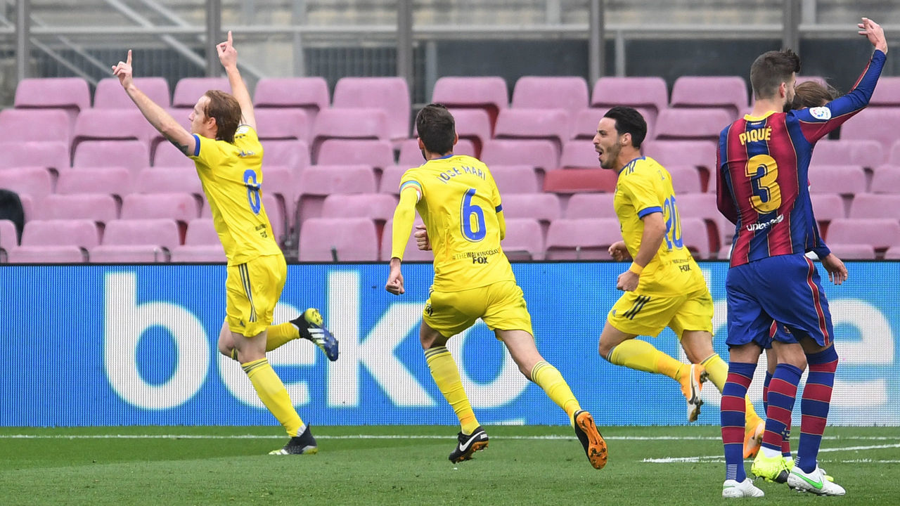 BARCELONA, SPAIN - FEBRUARY 21: Alex Fernandez of Cadiz CF celebrates with team mates (L - R) Jose Mari and Isaac Carcelen after scoring their side's first goal from the penalty spot during the La Liga Santander match between FC Barcelona and Cadiz CF at Camp Nou on February 21, 2021 in Barcelona, Spain. Sporting stadiums around Spain remain under strict restrictions due to the Coronavirus Pandemic as Government social distancing laws prohibit fans inside venues resulting in games being played behind closed doors.