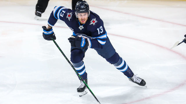 WINNIPEG, MB - FEBRUARY 11: Pierre-Luc Dubois #13 of the Winnipeg Jets keeps an eye on the play during first period action against the Ottawa Senators at Bell MTS Place on February 11, 2021 in Winnipeg, Manitoba.