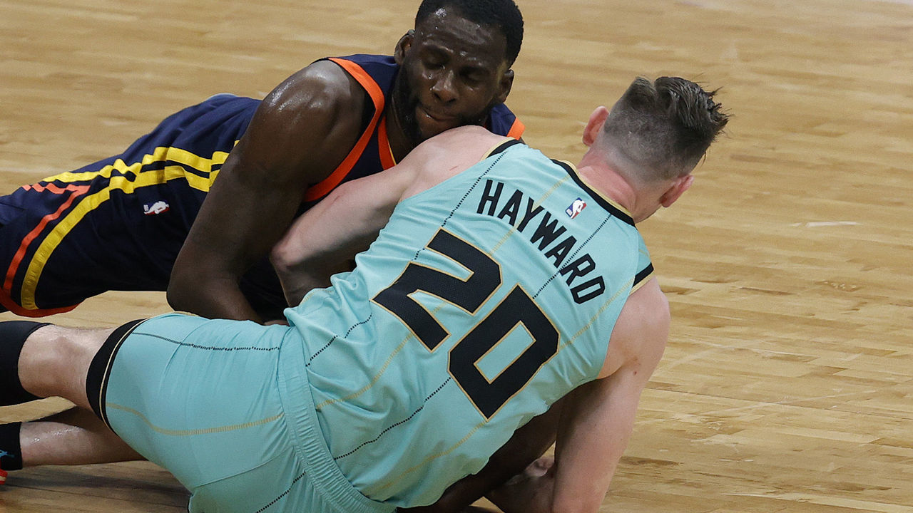 CHARLOTTE, NORTH CAROLINA - FEBRUARY 20: Draymond Green #23 of the Golden State Warriors battles for possession with Gordon Hayward #20 of the Charlotte Hornets during the fourth quarter of their game at Spectrum Center on February 20, 2021 in Charlotte, North Carolina.
