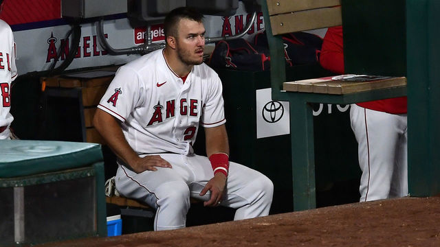 ANAHEIM, CA - SEPTEMBER 18: Mike Trout #27 of the Los Angeles Angels sits in the dugout during the game against the Texas Rangers at Angel Stadium of Anaheim on September 18, 2020 in Anaheim, California.