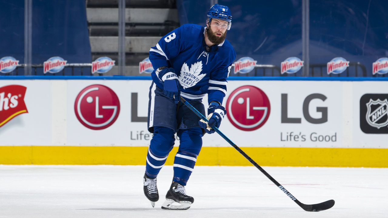 TORONTO, ON - FEBRUARY 13: Jake Muzzin #8 of the Toronto Maple Leafs plays the puck against the Montreal Canadiens during the first period at the Scotiabank Arena on February 13, 2021 in Toronto, Ontario, Canada.