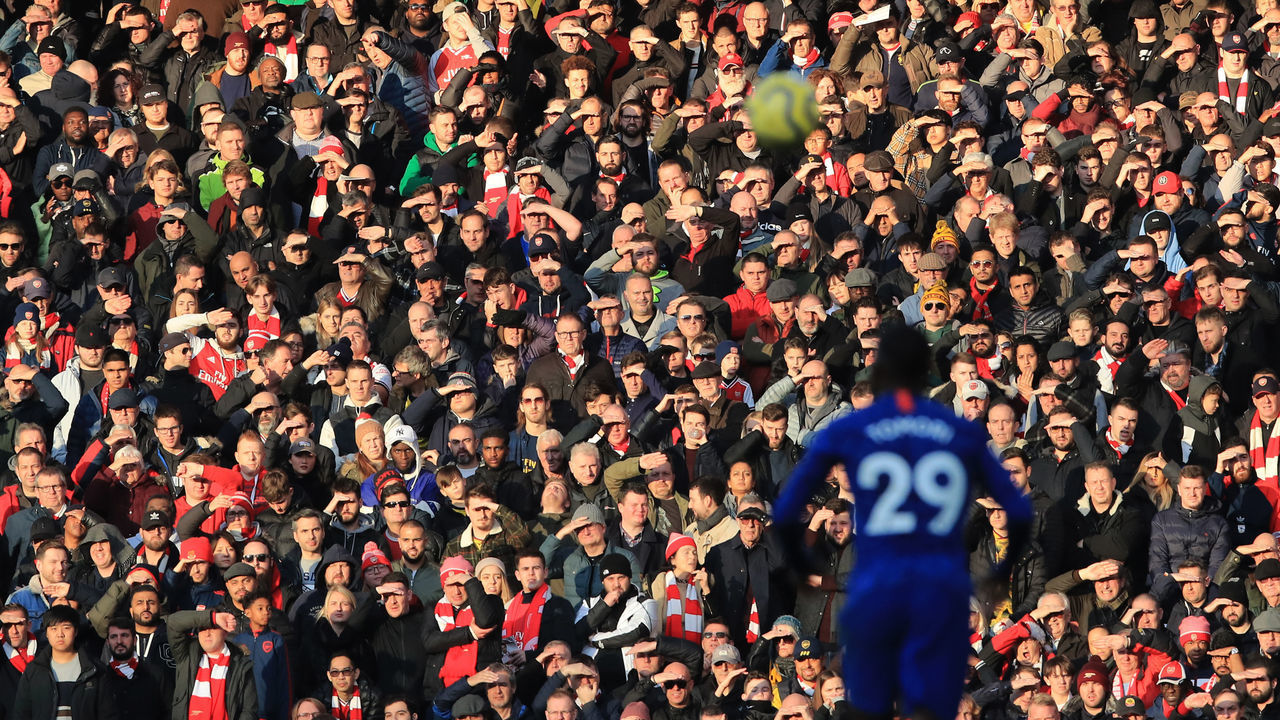 LONDON, ENGLAND - DECEMBER 29: Arsenal fans shield there eyes abasing the low sun during the Premier League match between Arsenal FC and Chelsea FC at Emirates Stadium on December 29, 2019 in London, United Kingdom.
