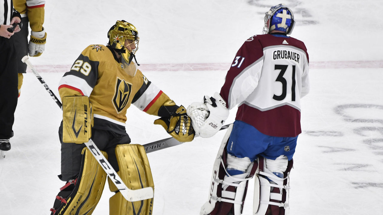LAS VEGAS, NEVADA - FEBRUARY 14: Philipp Grubauer #31 of the Colorado Avalanche and Marc-Andre Fleury #29 of the Vegas Golden Knights tap gloves after the second period of their game at T-Mobile Arena on February 14, 2021 in Las Vegas, Nevada.