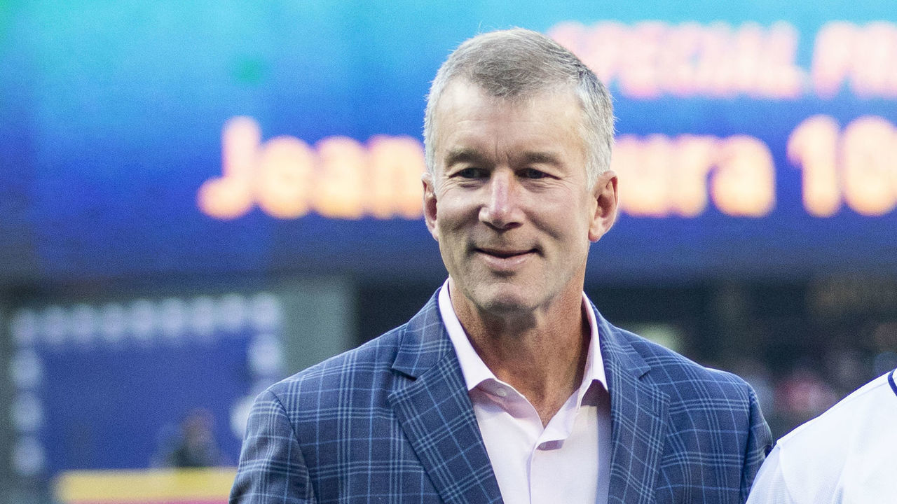 SEATTLE, WA - SEPTEMBER 03: Seattle Mariners President Kevin Mather, left and CEO John Stanton pose with Jean Segura #2 of the Seattle Mariners as he is presented with a plaque commemorating his 1,000th career hit before the game against the Baltimore Orioles at Safeco Field on September 3, 2018 in Seattle, Washington.