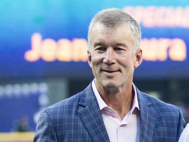 SEATTLE, WA - SEPTEMBER 03: Seattle Mariners President Kevin Mather, left and CEO John Stanton pose with Jean Segura #2 of the Seattle Mariners as he is presented with a plaque commemorating his 1,000th career hit before the game against the Baltimore Orioles at Safeco Field on September 3, 2018 in Seattle, Washington.