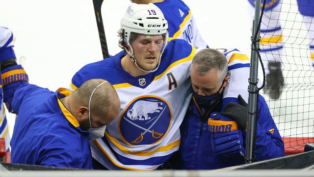 NEWARK, NJ - FEBRUARY 20: Buffalo Sabres defenseman Jake McCabe (19) is helped to the locker room by training staff after being injured during the third period of the National Hockey League game between the New Jersey Devils and the Buffalo Sabres on February 20, 2021 at the Prudential Center in Newark, NJ.