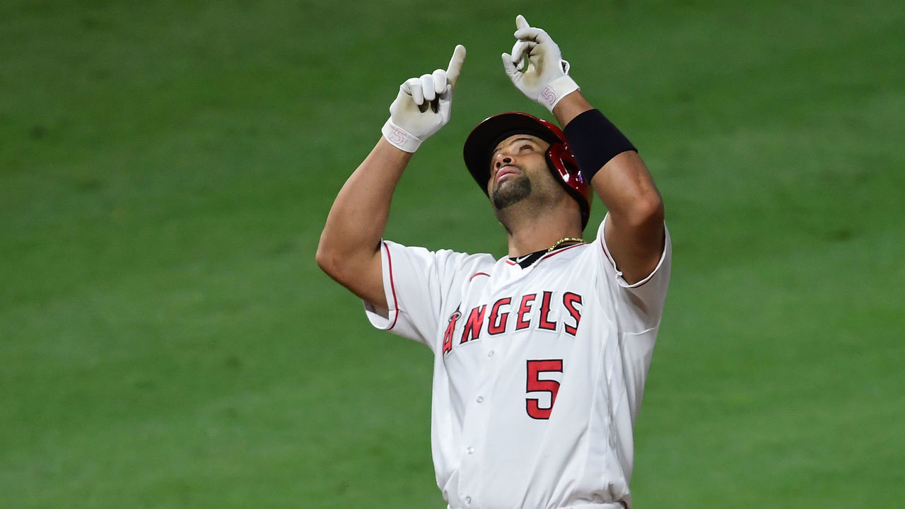 ANAHEIM, CA - SEPTEMBER 18: Albert Pujols #5 of the Los Angeles Angels points to the sky as he crosses the plate after hitting home run #662, his second of the night, in the seventh inning of the game against the Texas Rangers at Angel Stadium of Anaheim on September 18, 2020 in Anaheim, California.