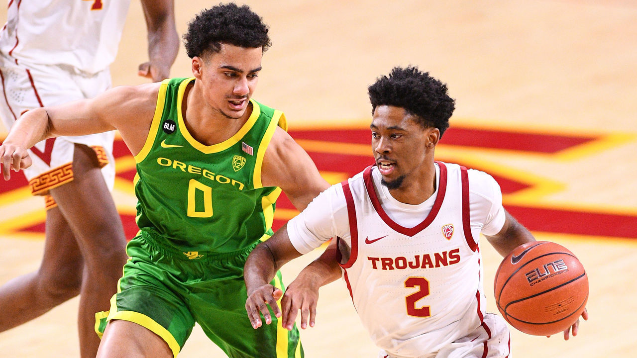 LOS ANGELES, CA - FEBRUARY 22: USC Trojans guard Tahj Eaddy (2) drives past Oregon guard Will Richardson (0) during the college basketball game between the Oregon Ducks and the USC Trojans on February 22, 2021 at Galen Center in Los Angeles, CA. The game was played without fans due to the COVID-19 pandemic.